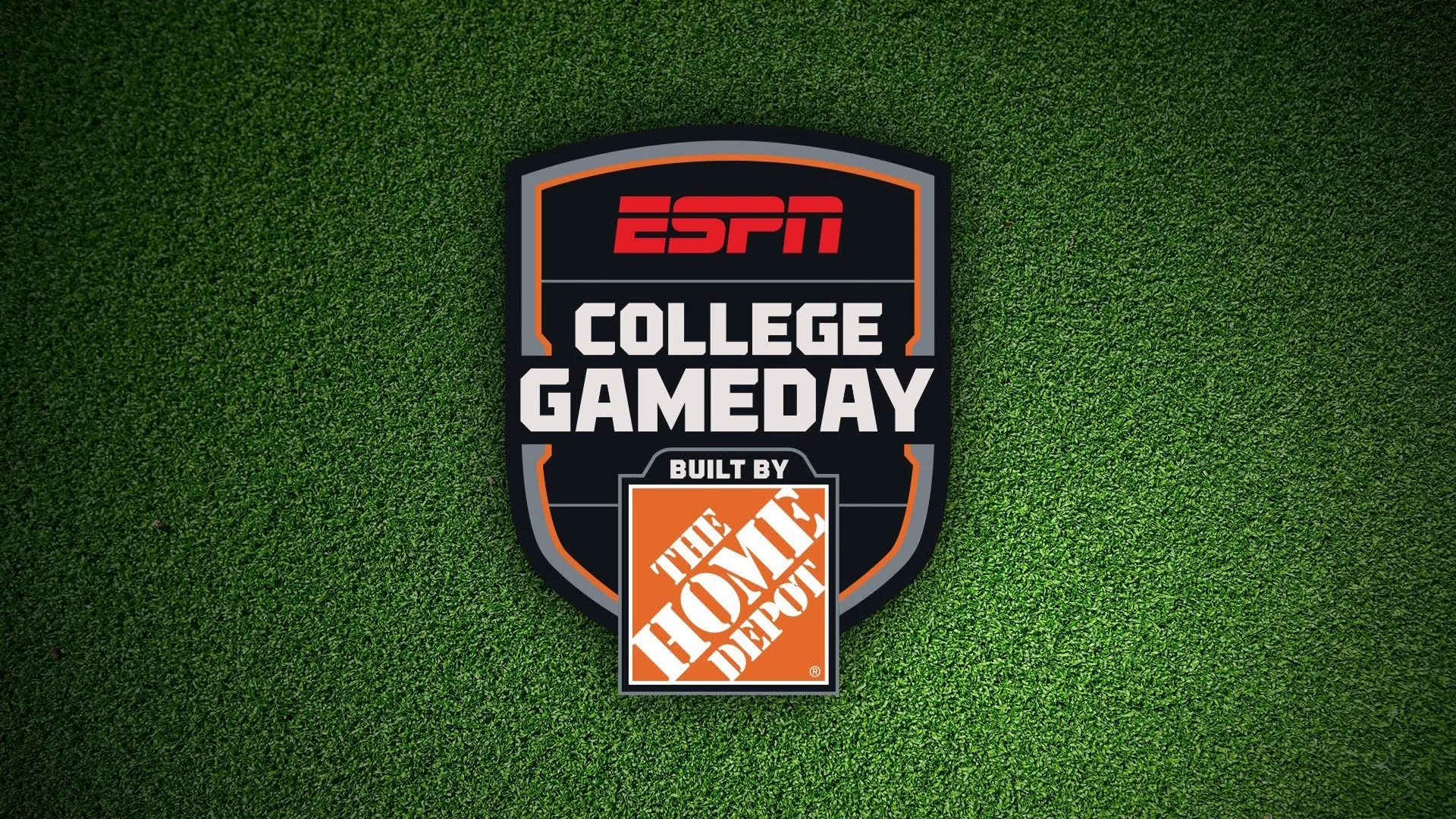 The ESPN College GameDay logo, featuring "Built by The Home Depot" branding, is centered on a textured green turf background.