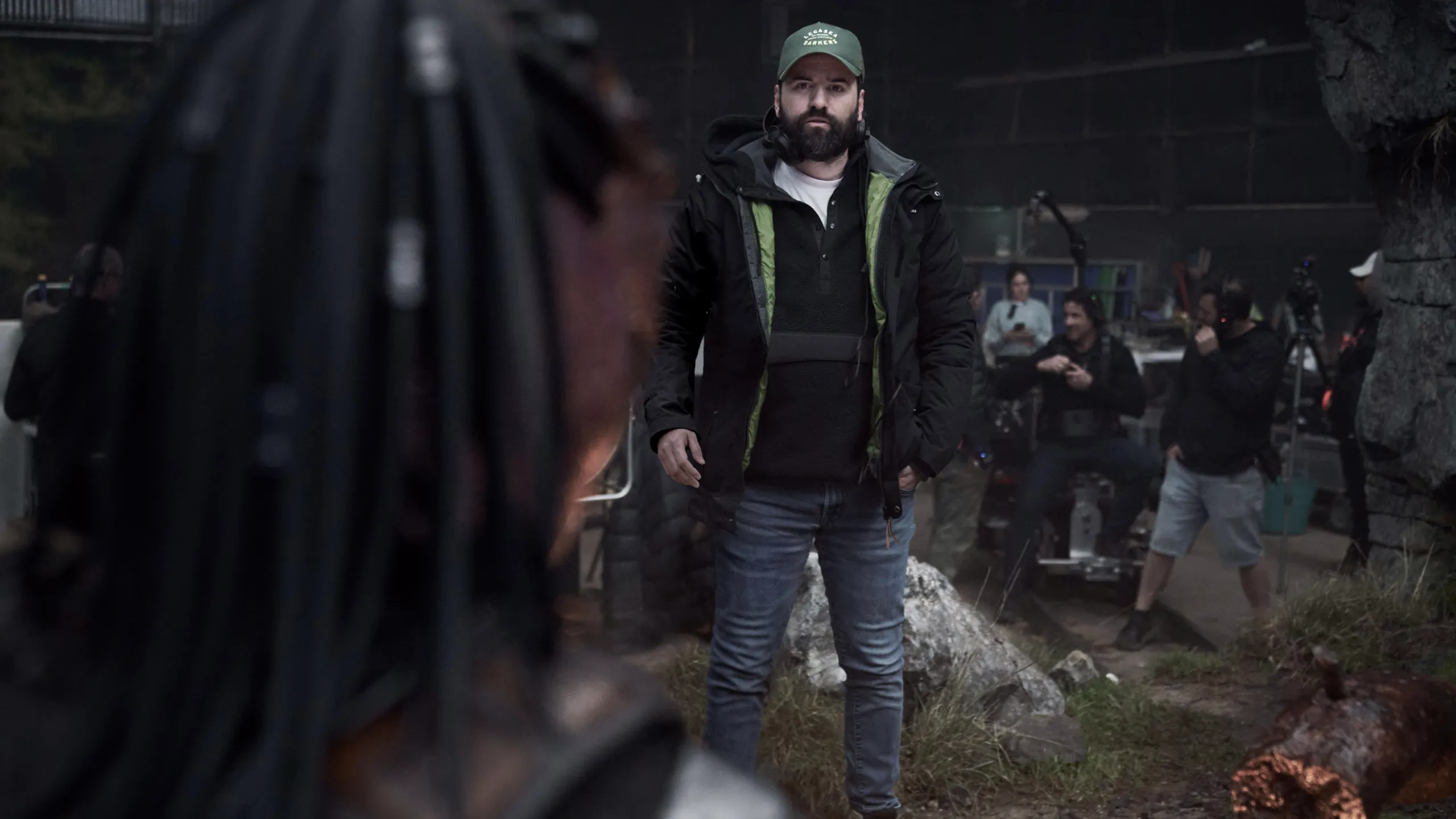 Director Dan Trachtenberg talking to actors on the set of Predator: Badlands