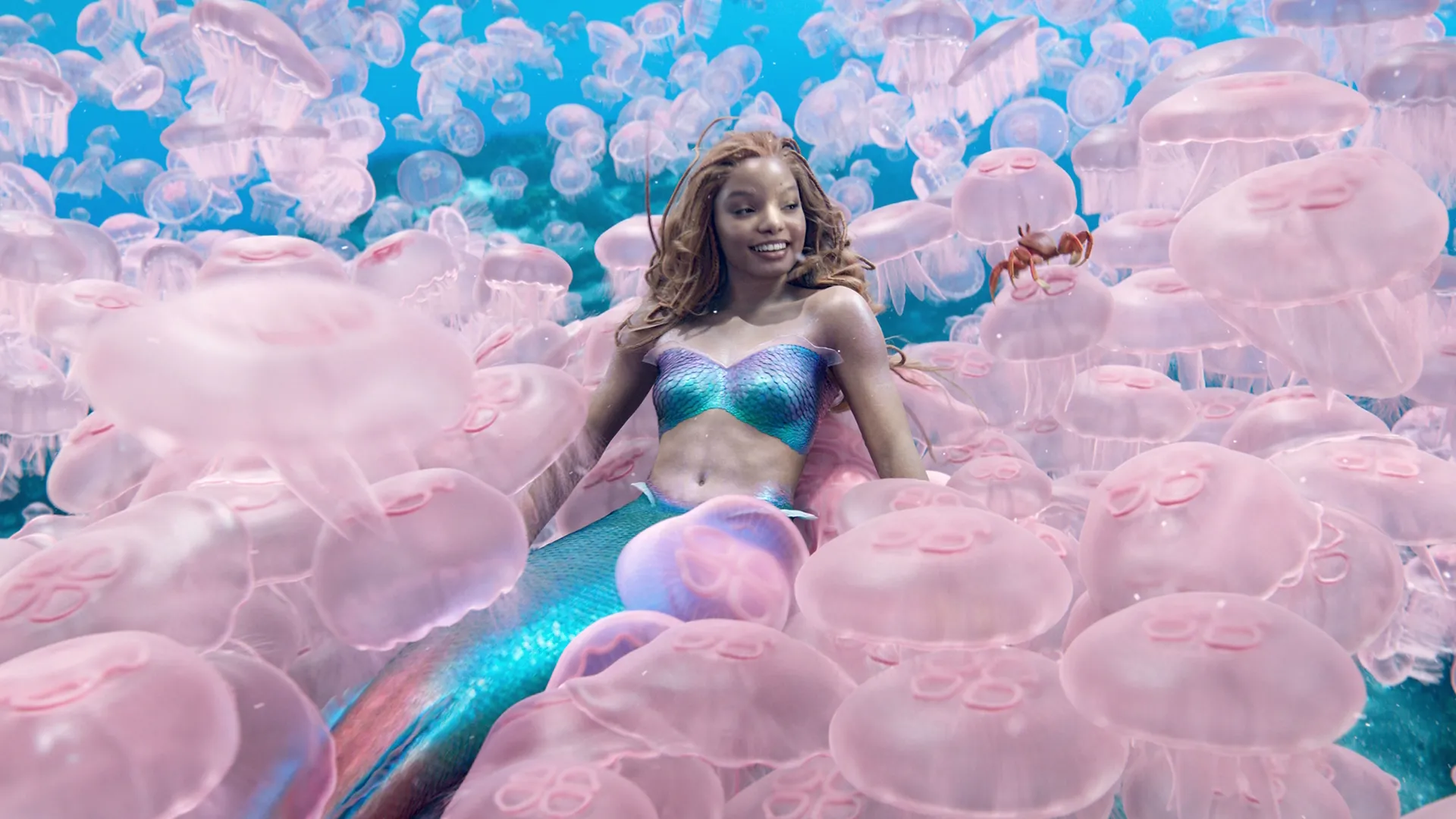 Halle Bailey as Ariel among jelly fish under the sea in The Little Mermaid (2023)