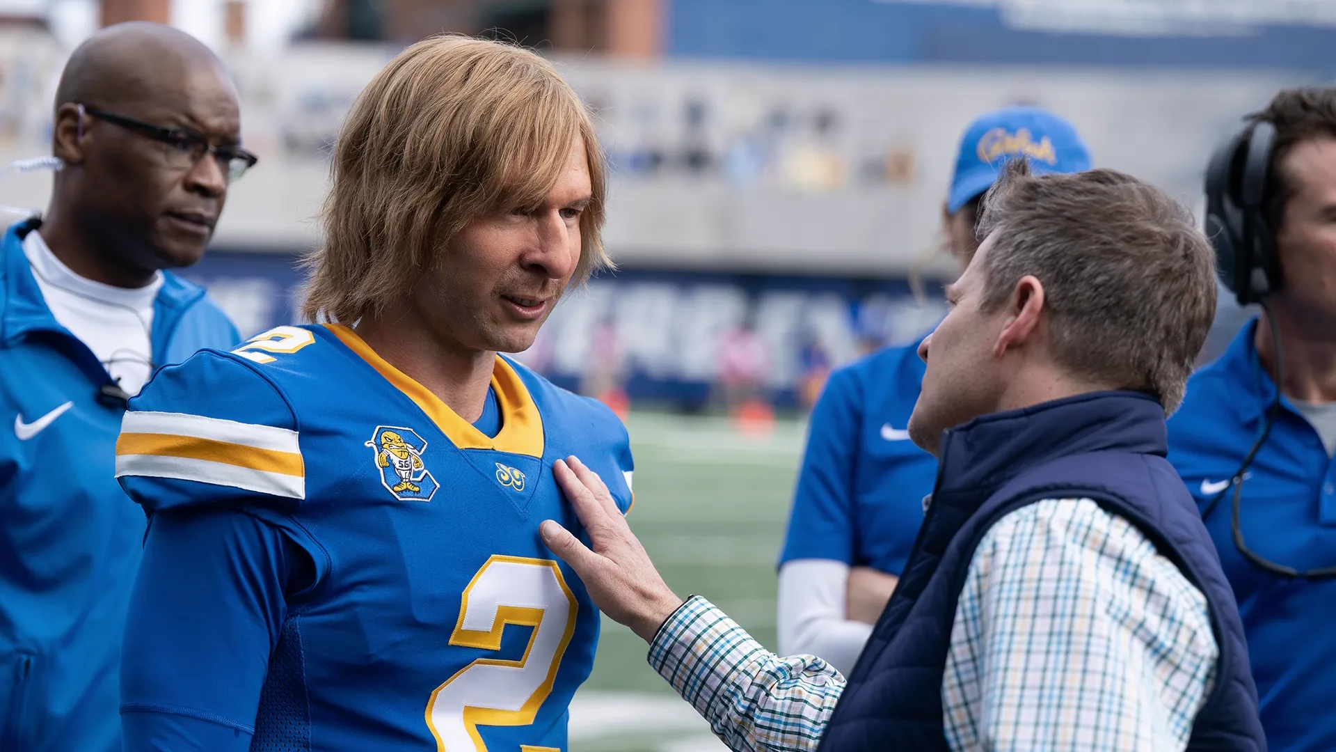 Chad Powers talking with a South Georgia Catfish staff member on the sidelines in Chad Powers