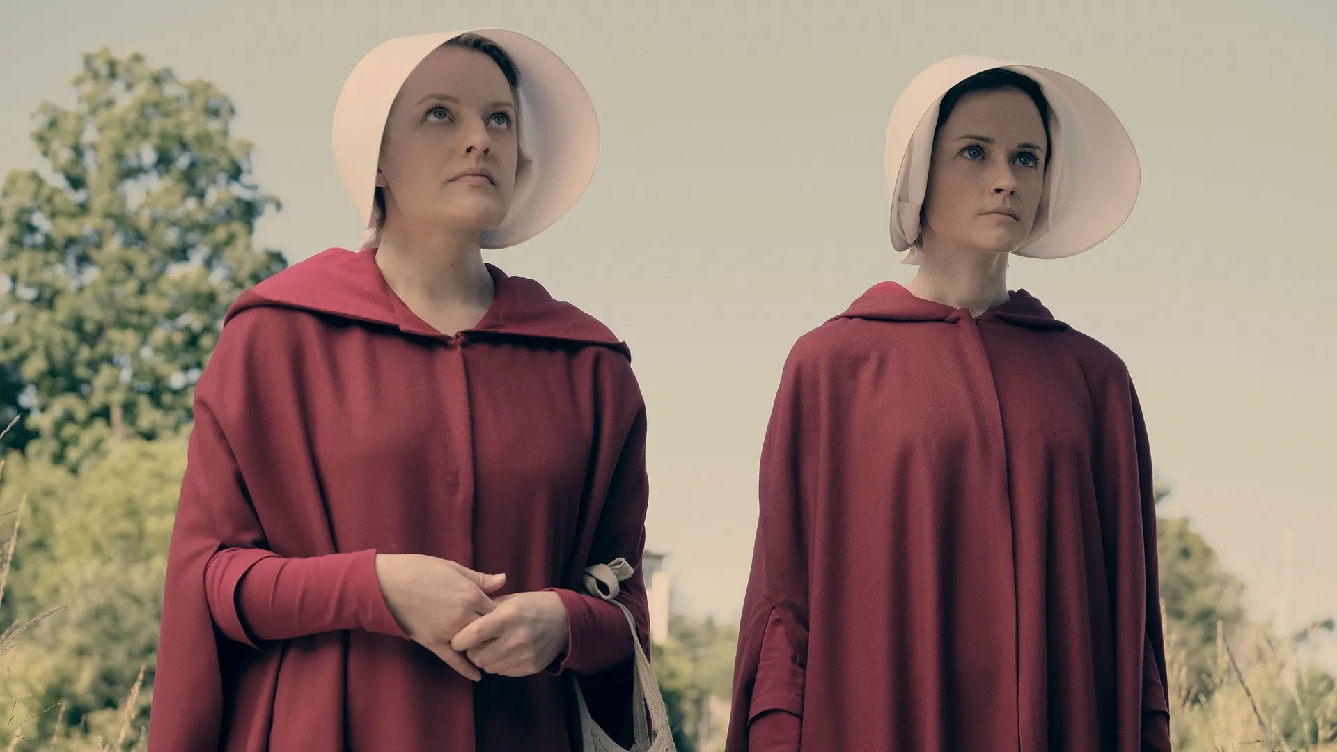 June Osborne (Elisabeth Moss) and Dr. Emily Malek (Alexis Bledel) in their Handmaid robes.
