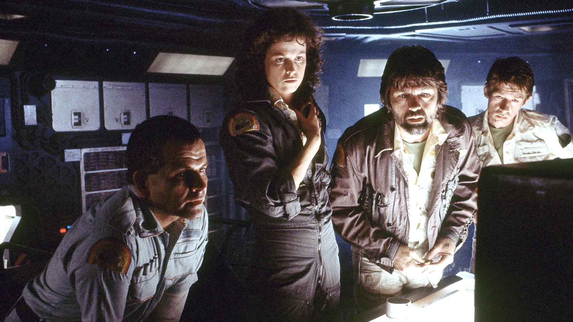 The crew of a spaceship, looking at a monitor