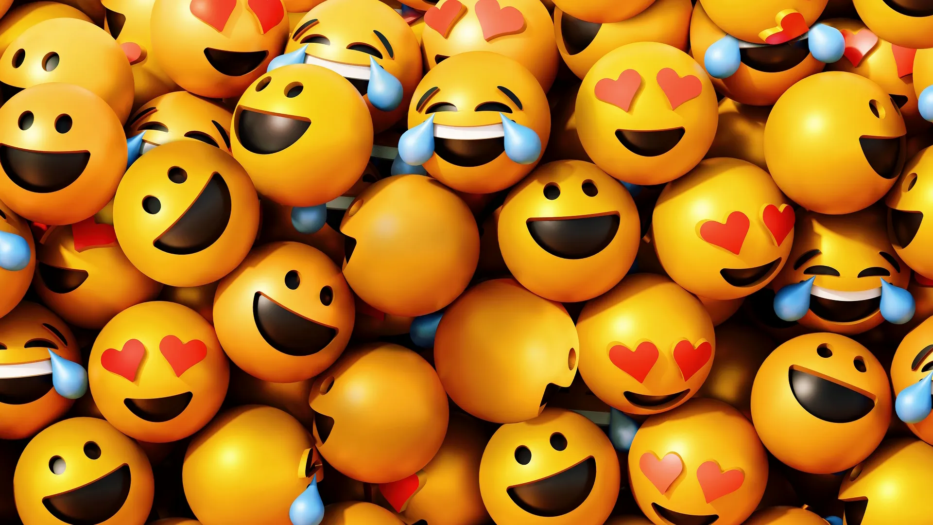 A dense pile of 3D yellow emojis featuring varying joyful expressions, including laughing with tears, smiling faces, and faces with red heart-eyes.