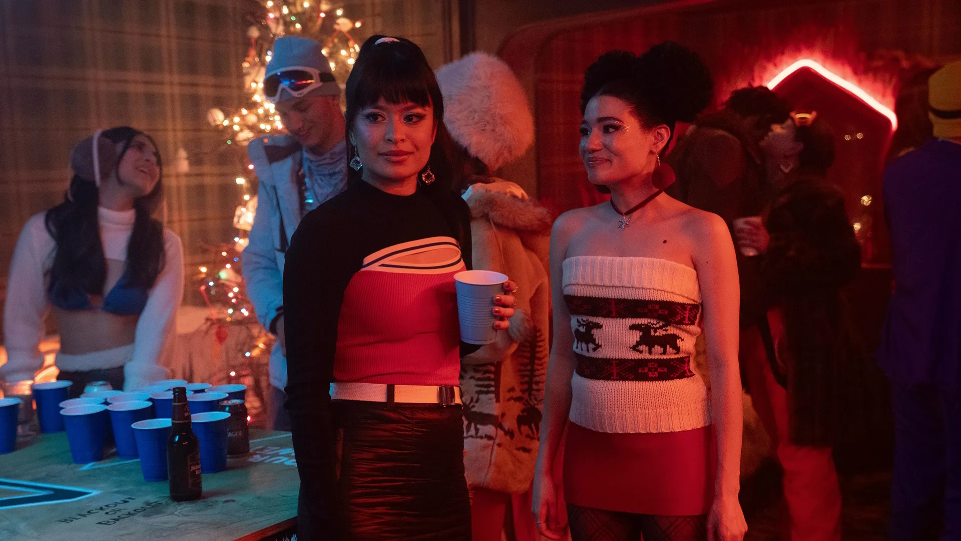 Pippa (Sonia Mena) and Diana (Alicia Crowder) at a party