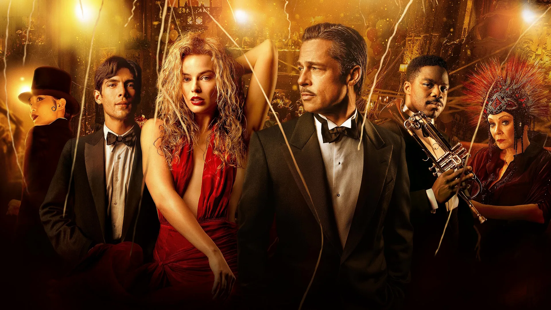 An ensemble promotional cast photo from the 2022 film Babylon, featuring Margot Robbie in a vibrant red dress and Brad Pitt in a classic tuxedo standing at the center of an extravagant, dimly lit golden party backdrop alongside fellow cast members.