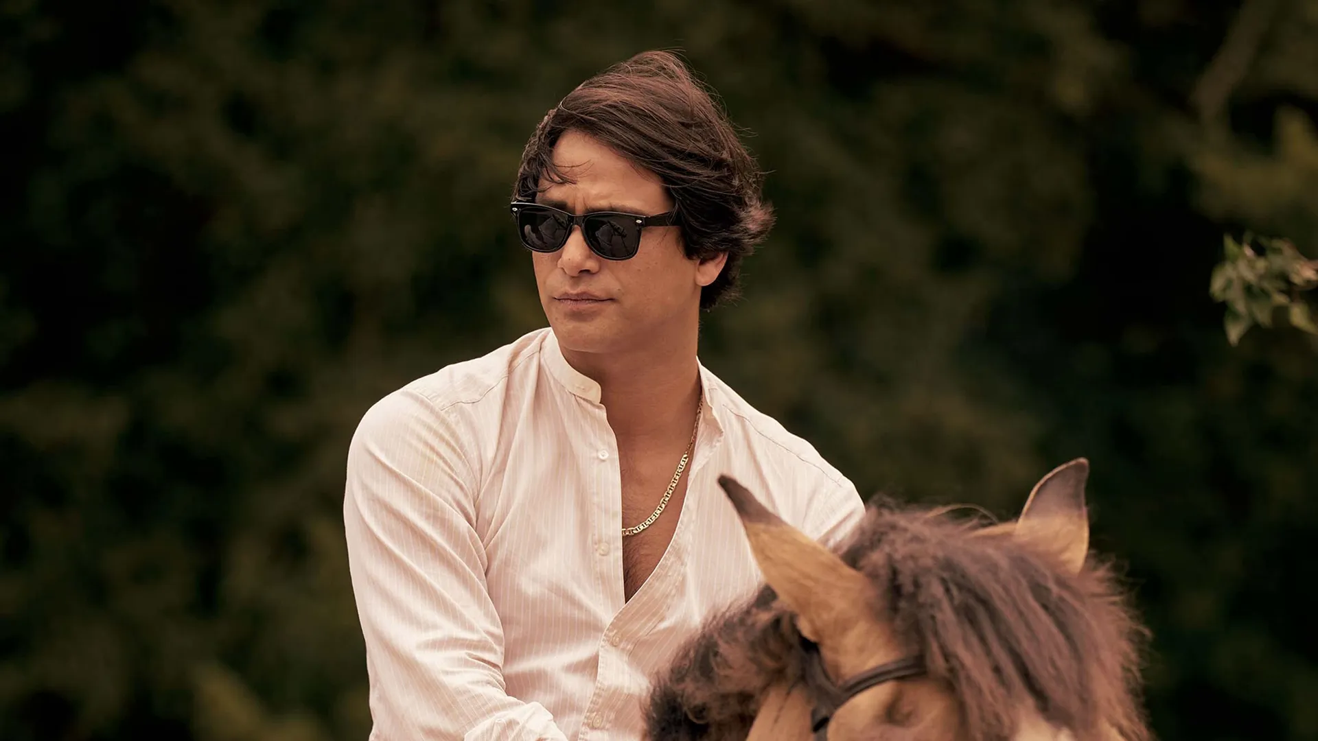 This image features actor Luke Pasqualino in his role as Bas Baddingham from the television series Rivals.