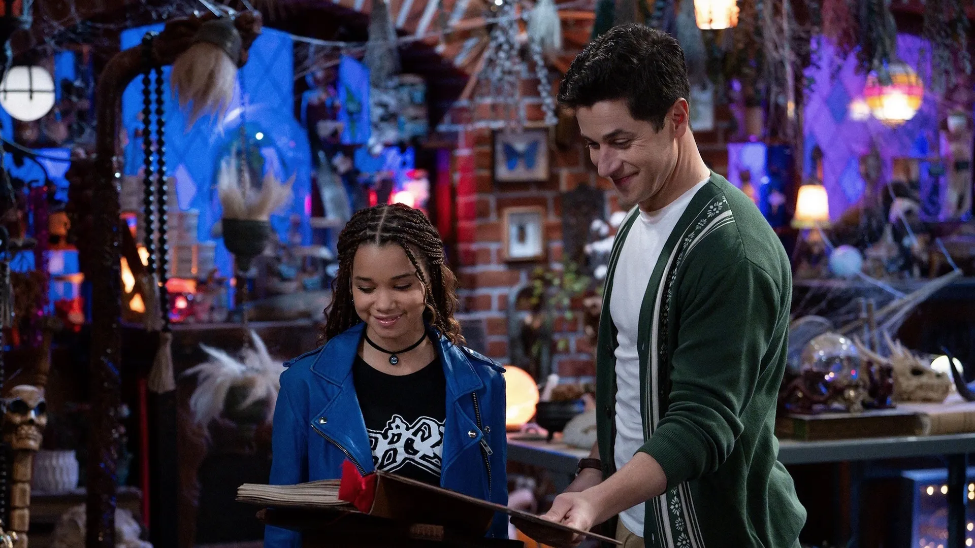 Justin Russo (David Henrie) shows Billie (Janice LeAnn Brown) a spell book in Wizards Beyond Waverly Place