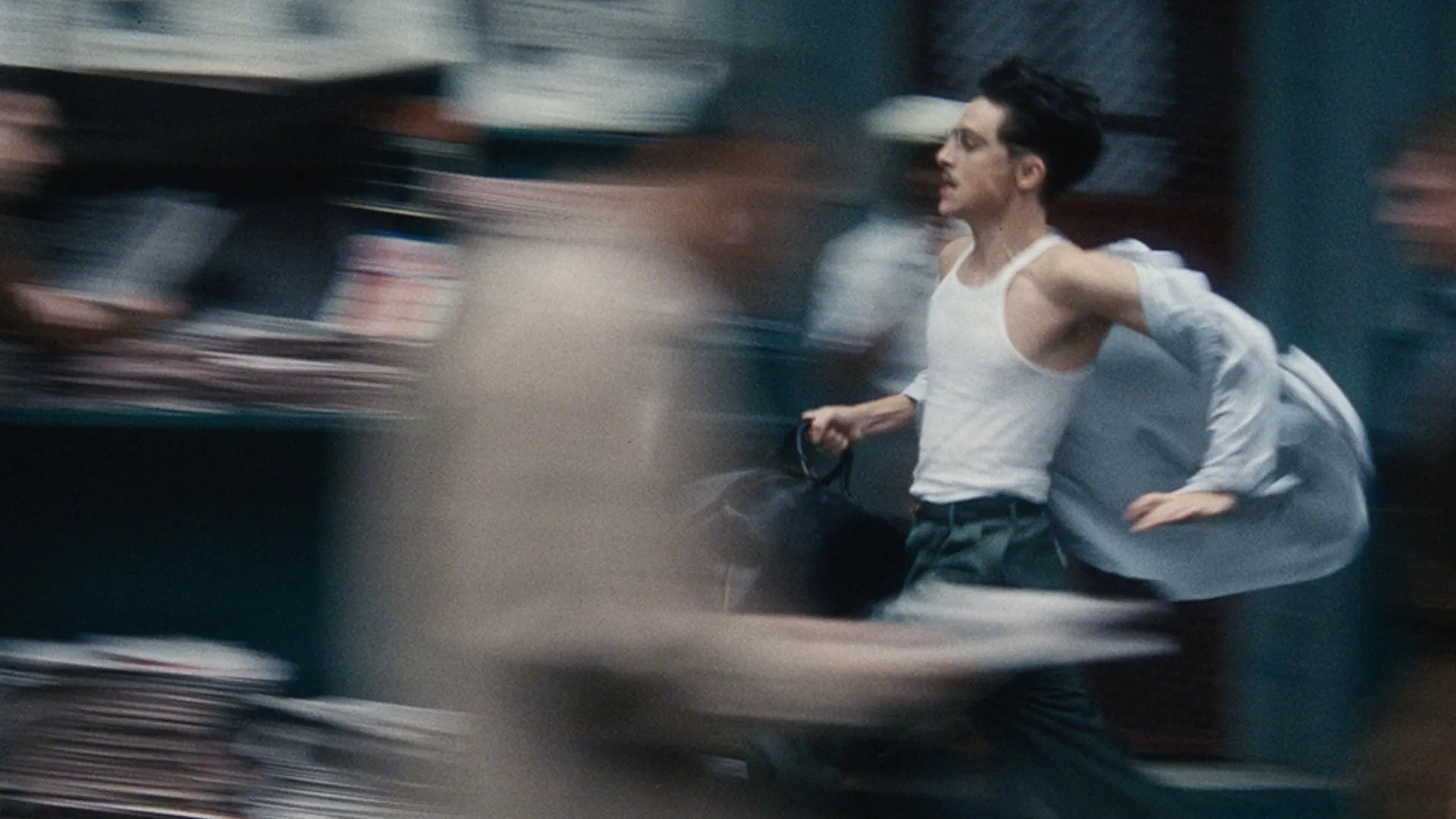 Marty Mauser (Timothée Chalamet) runs through the street in Marty Supreme