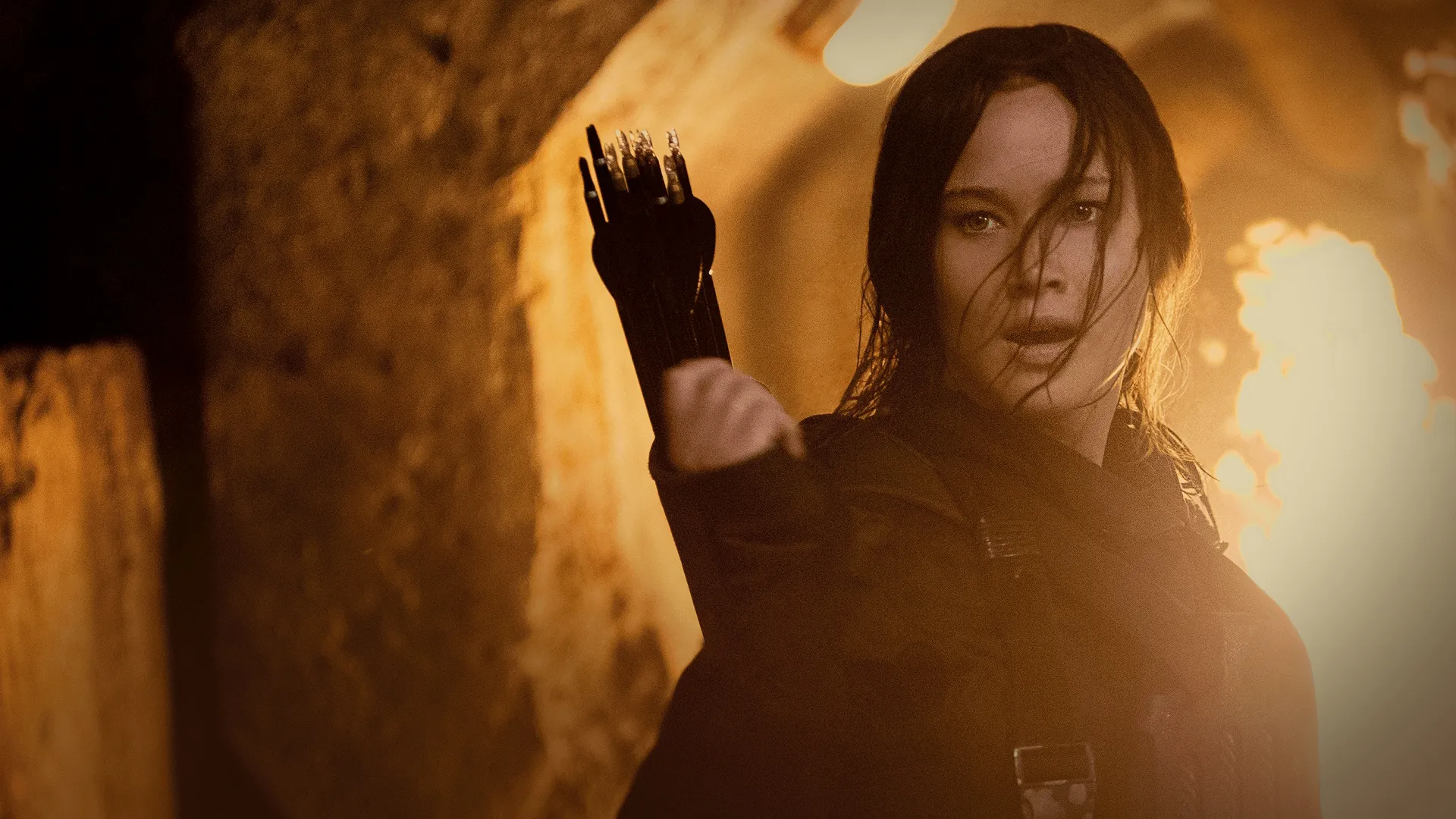 Jennifer Lawrence as Katniss Everdeen carrying a bow and arrows in The Hunger Games: Mockingjay – Part 2