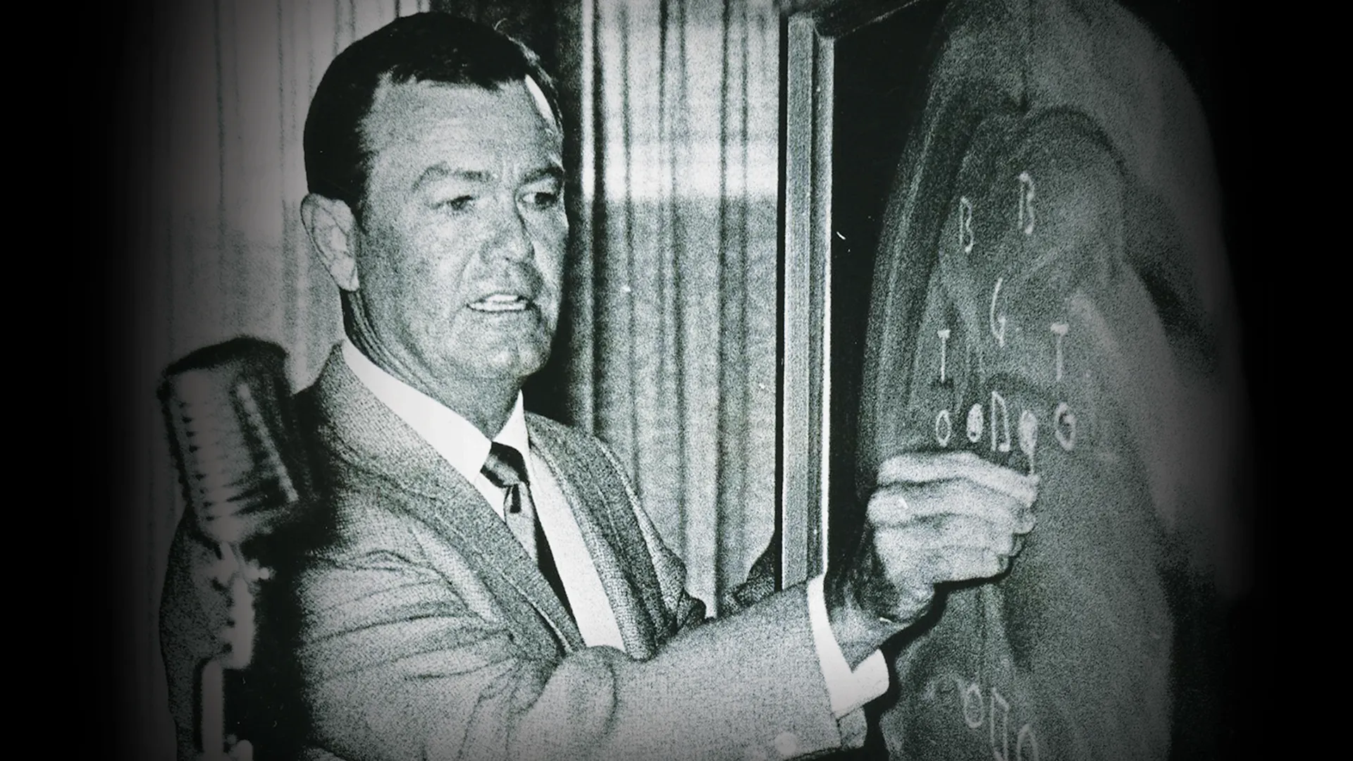Archie Manning writing play diagrams on a chalkboard.