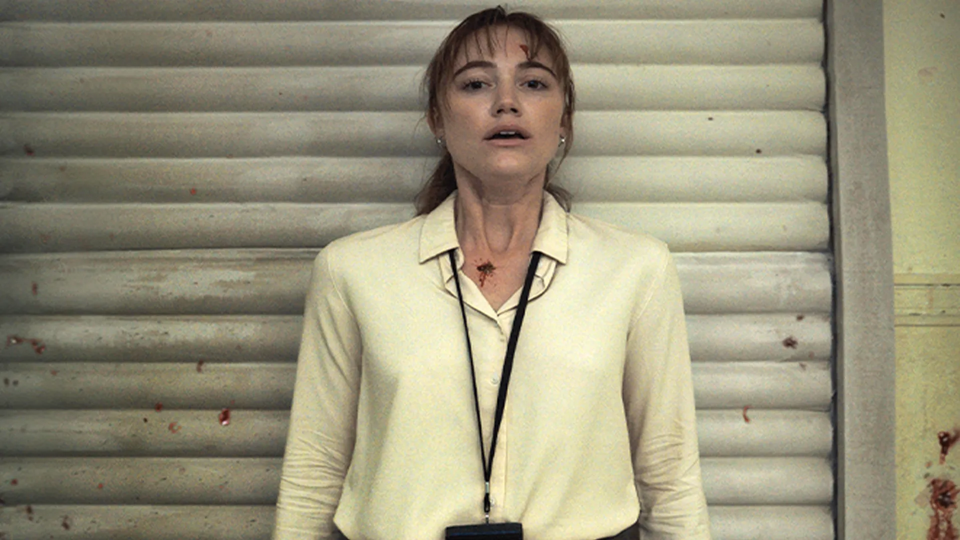 Lee Harker (Maika Monroe) is pressed up against a wall with a splattering of blood in Longlegs.