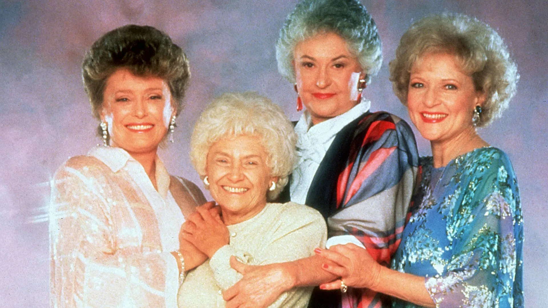 The Golden Girls beam as they pose for a group picture.
