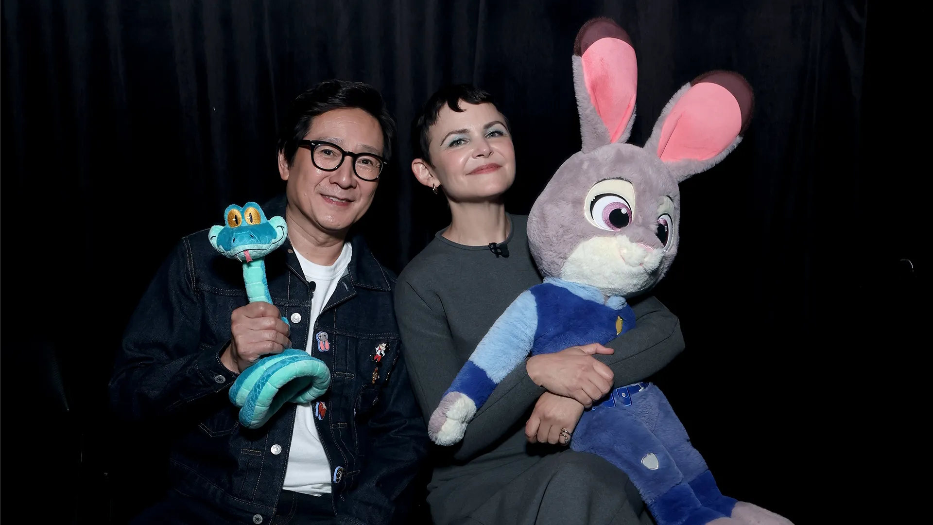 Ginnifer Goodwin and Ke Huy Quan holding plushies of their characters from Zootopia 2