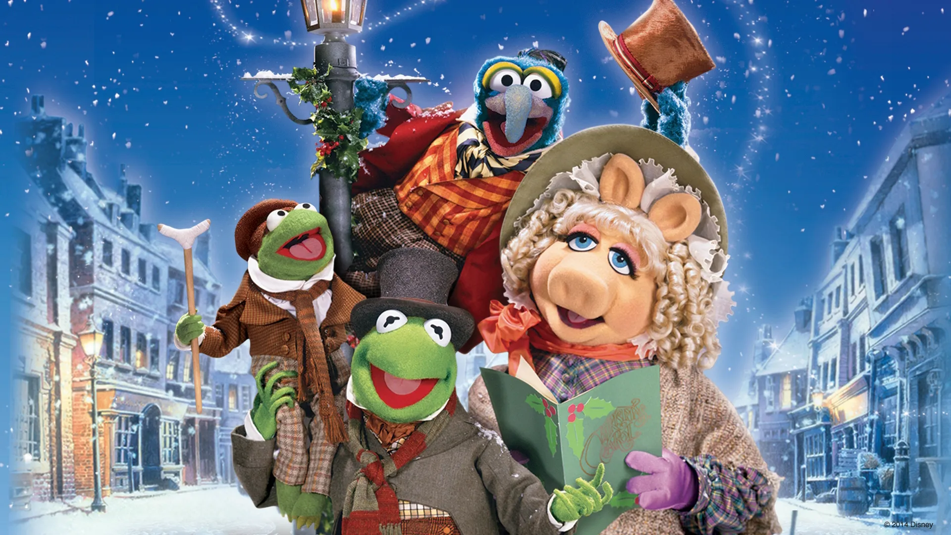 Promotional art featuring Kermit, Ms. Piggy, and Robin the Frog as the Cratchit family and Gonzo who narrates as Charles Dickens.