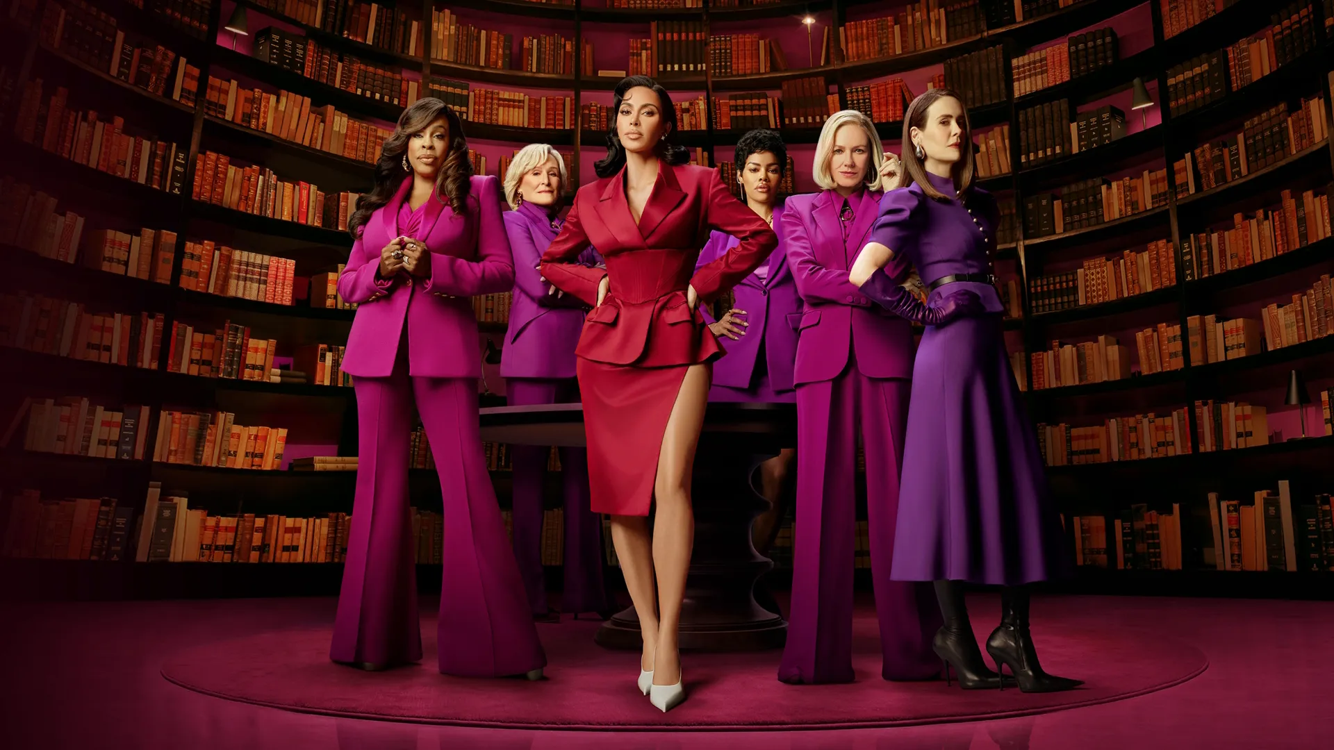 The cast of All's Fair standing in a library