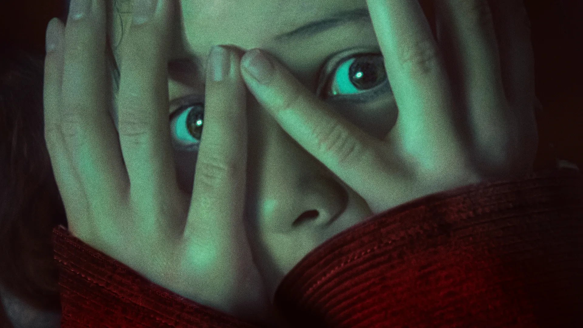 Julia Garner as Ginger covering her face in Wolf Man