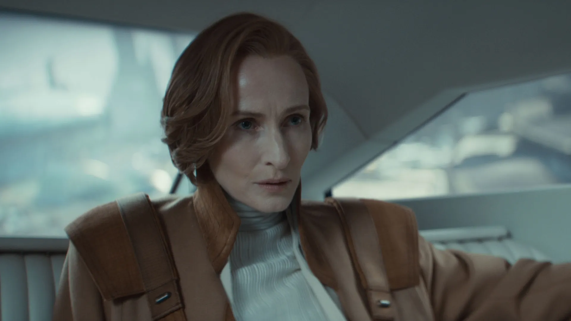 A concerned Mon Mothma (Genevieve O'Reilly) in the backseat of a vehicle.