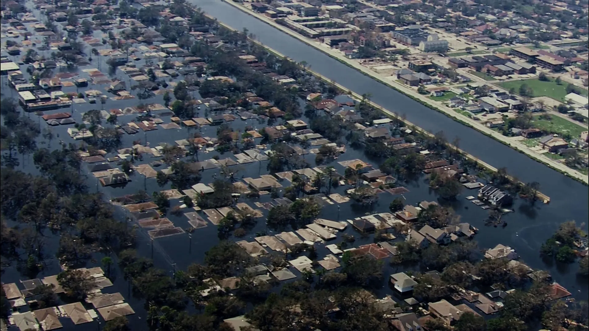 Wide shot of the devastation caused by Hurricane Katrina including flooded neighborhoods and destroyed homes.