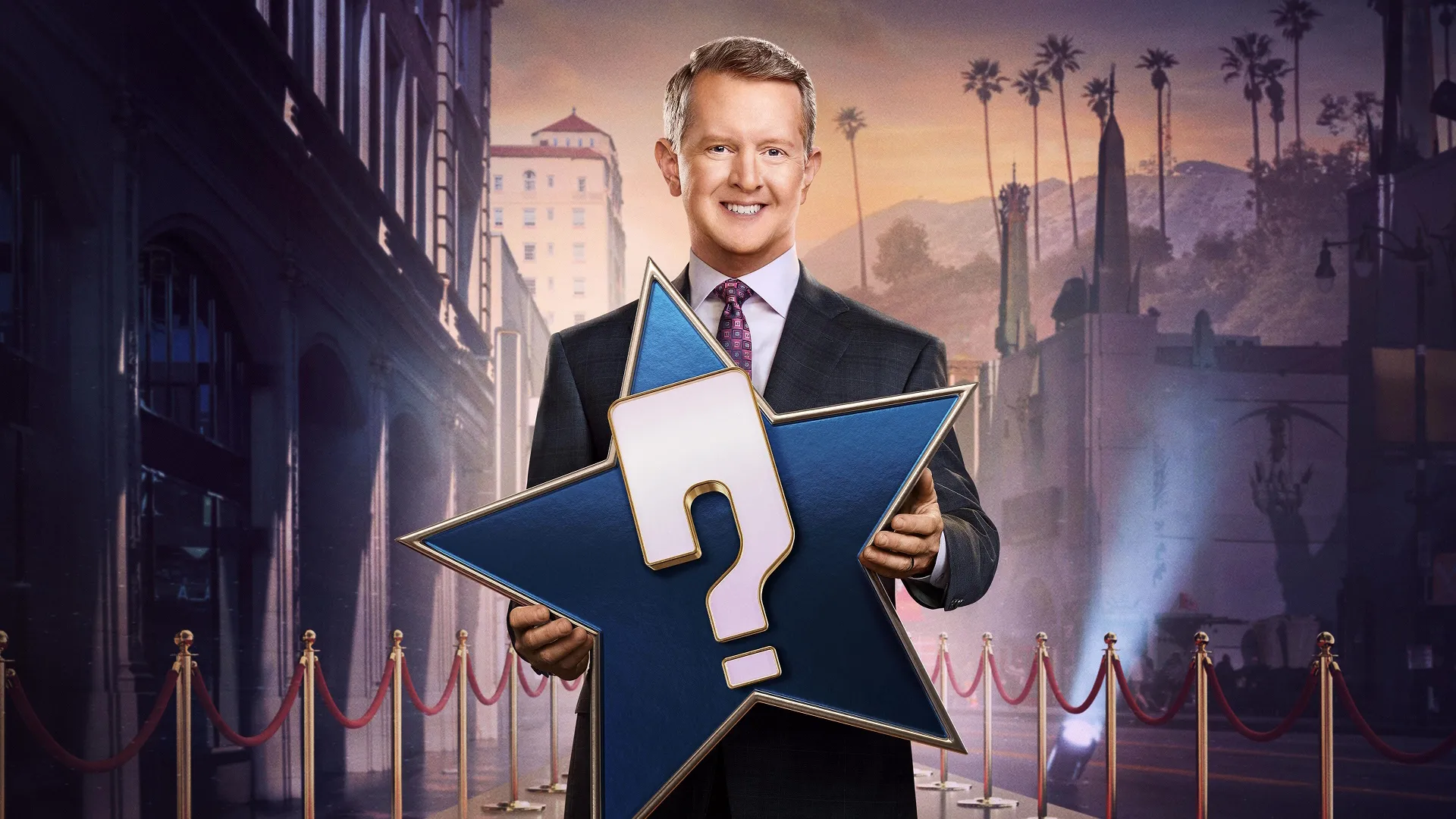 Host Ken Jennings posing with a star-shaped prop featuring a question mark