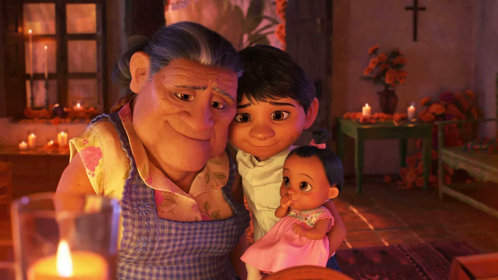 This image shows a scene from the 2017 Disney/Pixar film Coco, featuring the characters Mamá Coco, her great-grandson Miguel, and his baby sister Socorro. 
