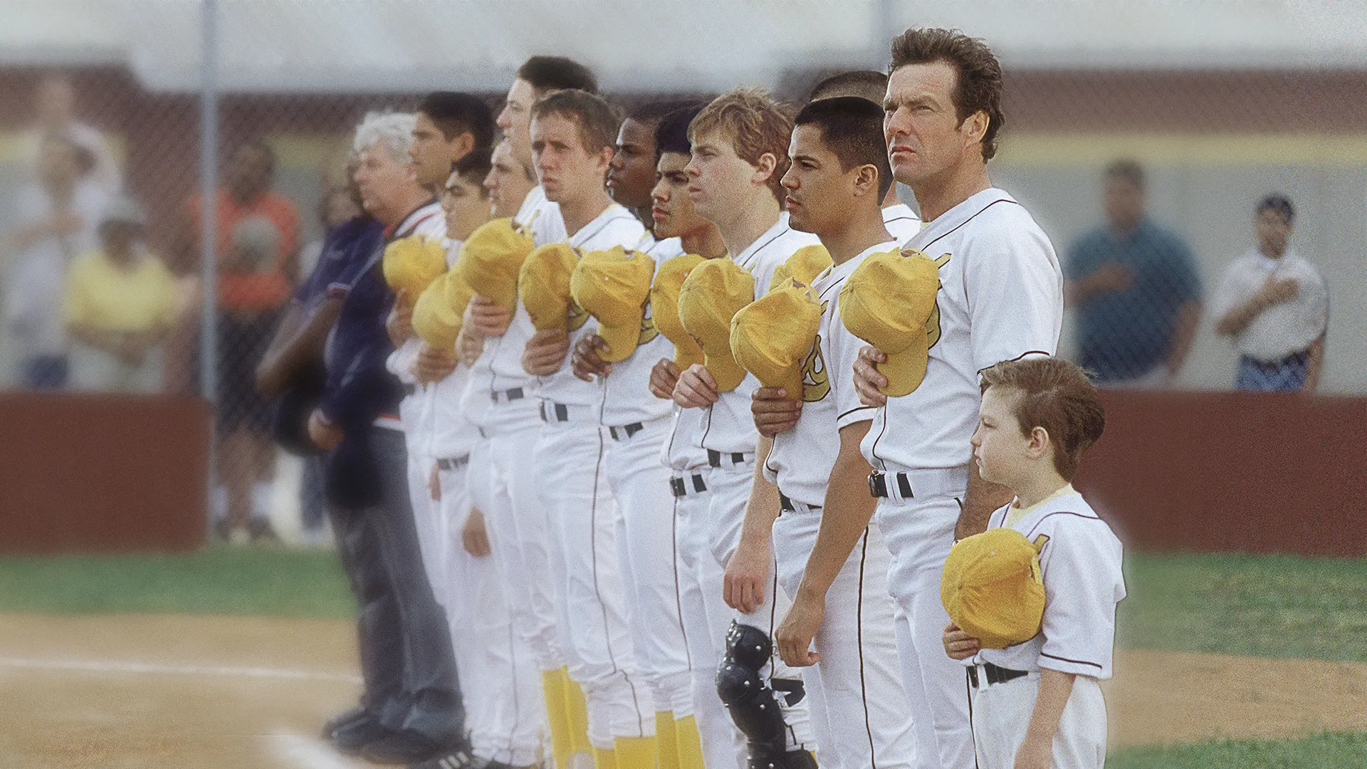 High-school baseball coach Jim Morris (Dennis Quaid) lineups up with his team.