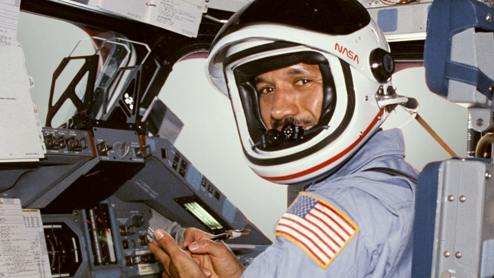 Charles F. Bolden Jr. at the pilot's station of the Space Shuttle.