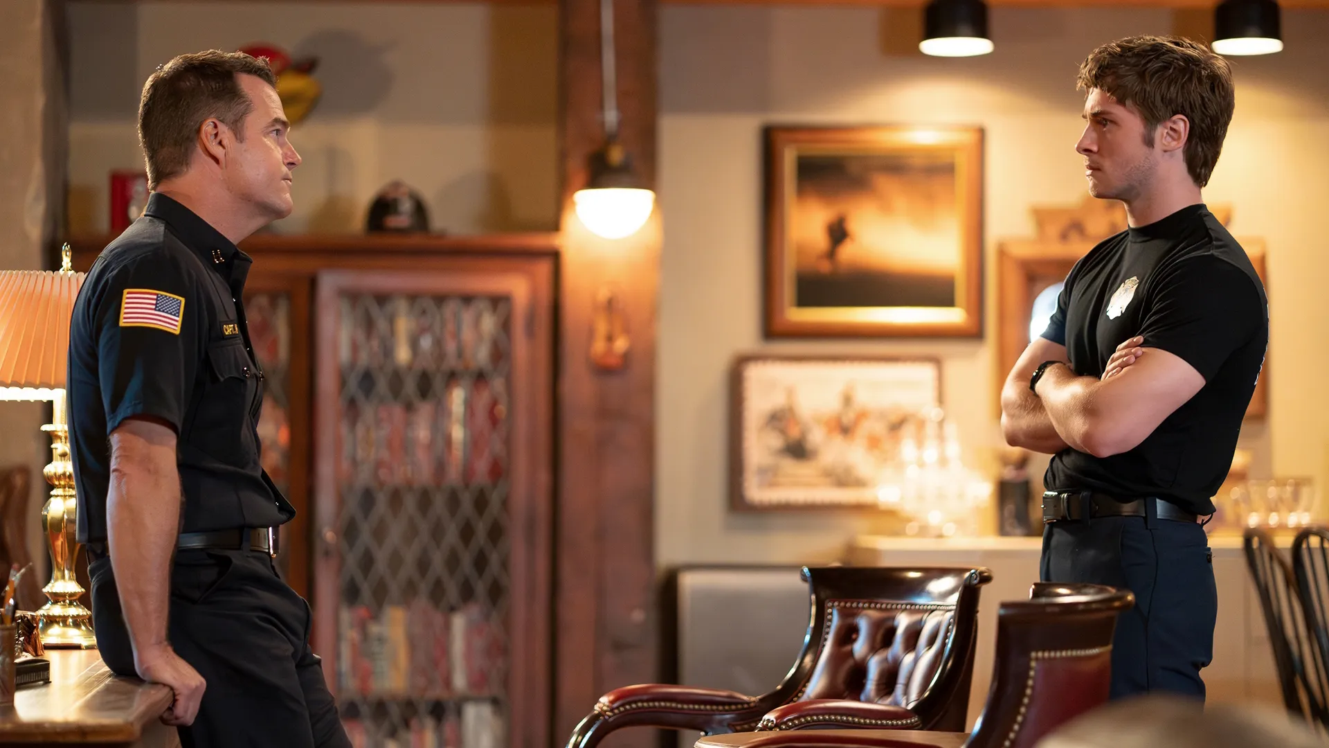 Captain Don Hart (Chris O'Donnell) and Ryan Hart (Michael Provost) stand facing each other, talking.