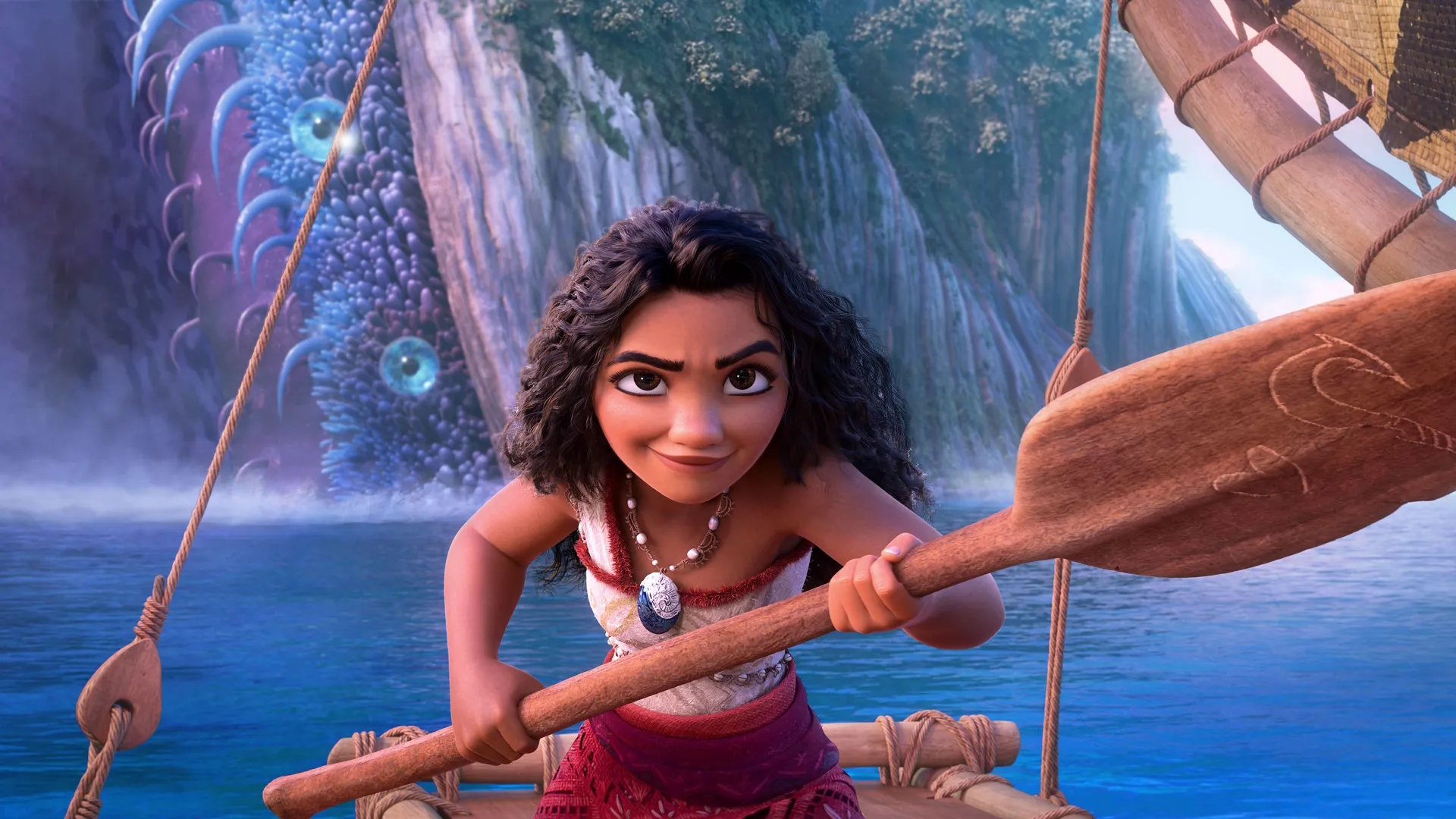 Moana stands at the ready with a paddle in her hand.