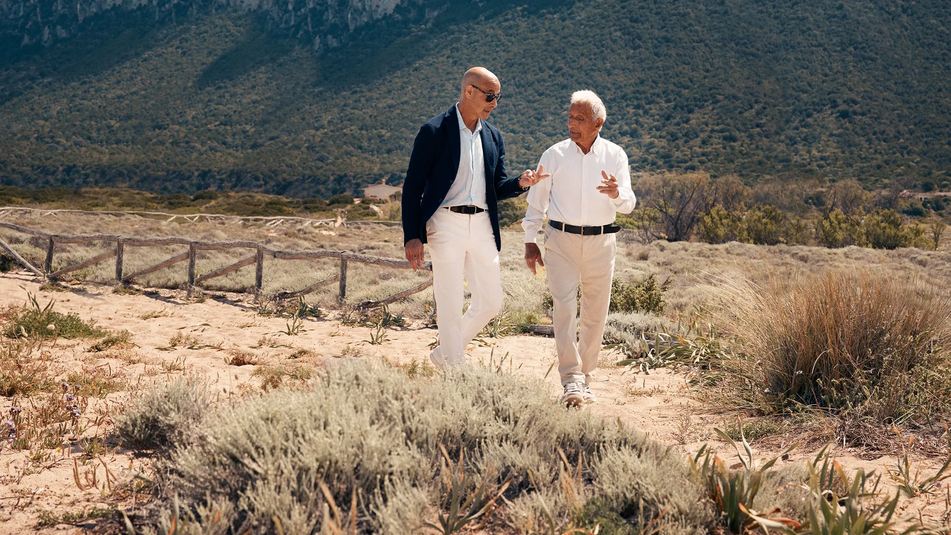 Stanley Tucci walks through the hilly Italian countryside with a local guide