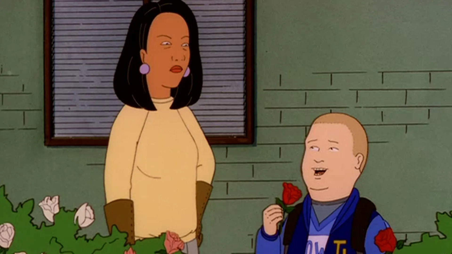 Bobby (Pamela Adlon) smiles and holds up a red rose beside Minh Souphanousinphone (Lauren Tom).