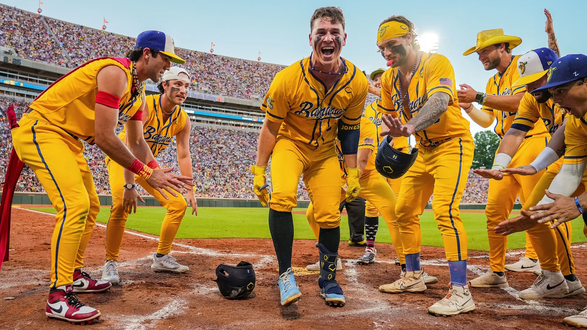 The Savannah Bananas team celebrates together.