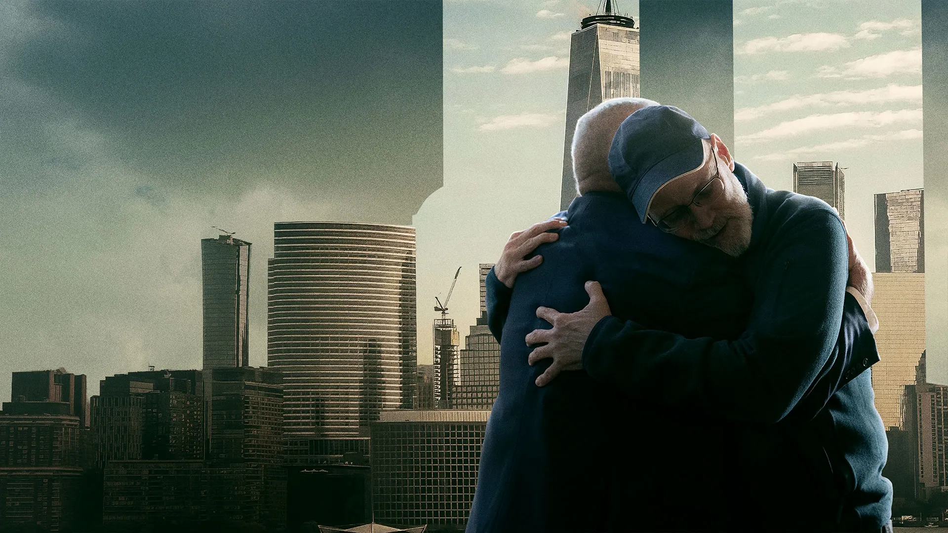 Key art for 9/11: Reunited featuring two people embracing in front of the New York City skyline and One World Trade Center.