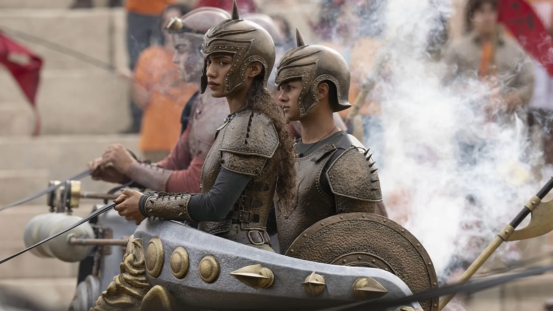 Clarisse La Rue (Dior Goodjohn) stands in a chariot in full armor.