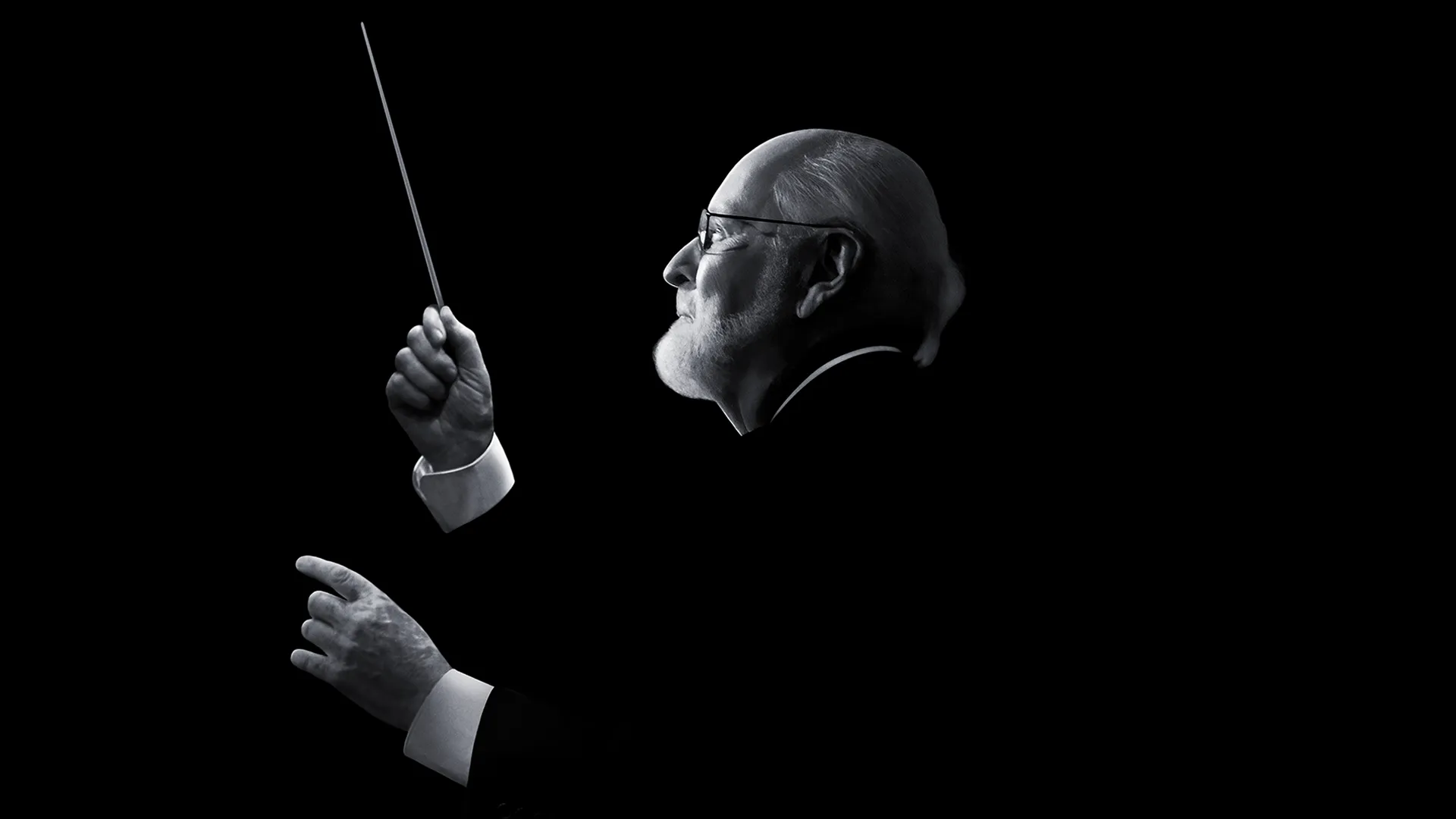 Black-and-white image of John Williams as he is composing.