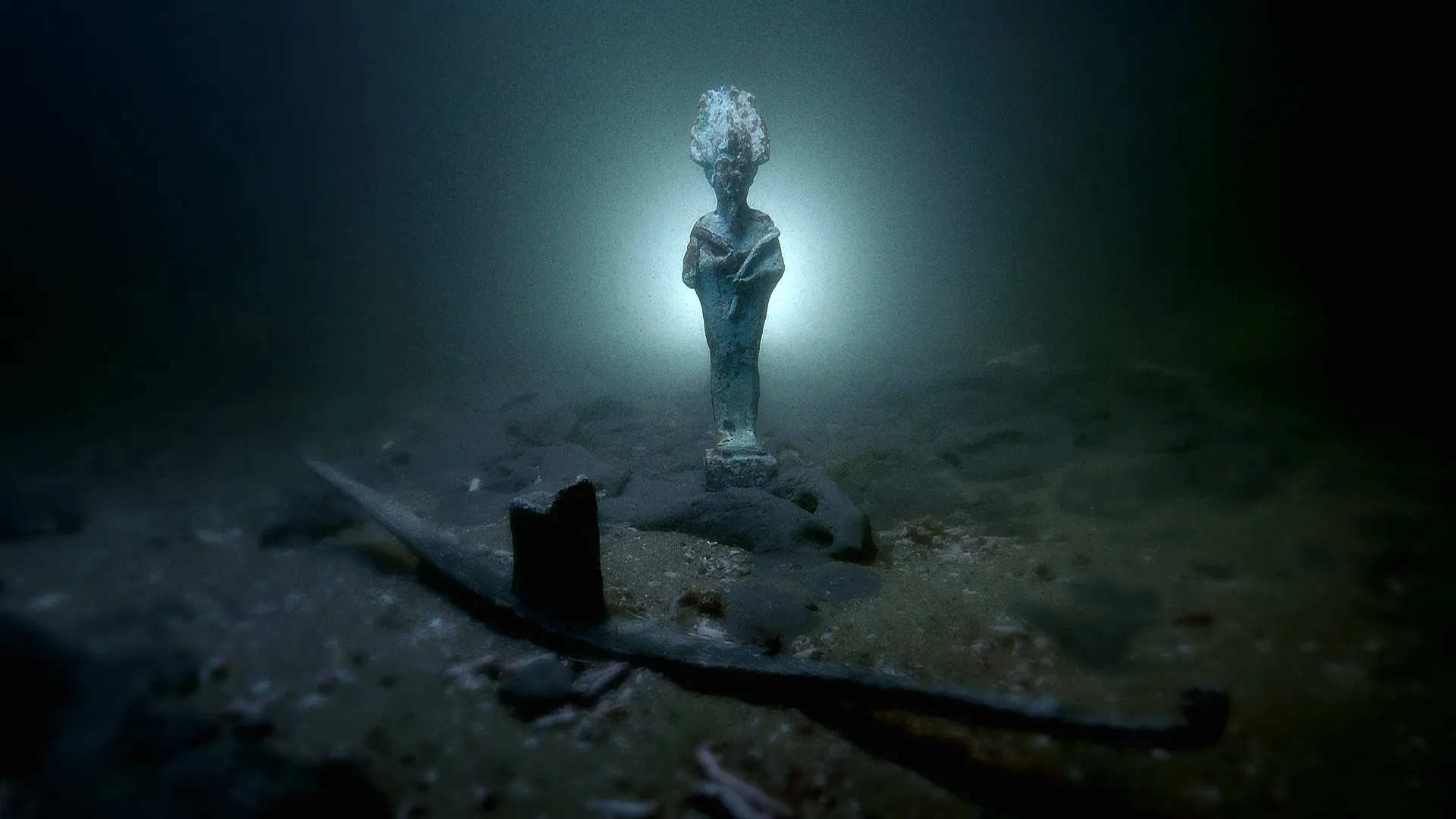 Bronze statuette of the Egyptian god Osiris discovered on the seabed of the sunken city of Thonis-Heracleion, off the coast of Egypt in Abu Qir Bay. The city, once a major port, was lost for over 1,200 years until its rediscovery by underwater archaeologist Franck Goddio in 2000.
