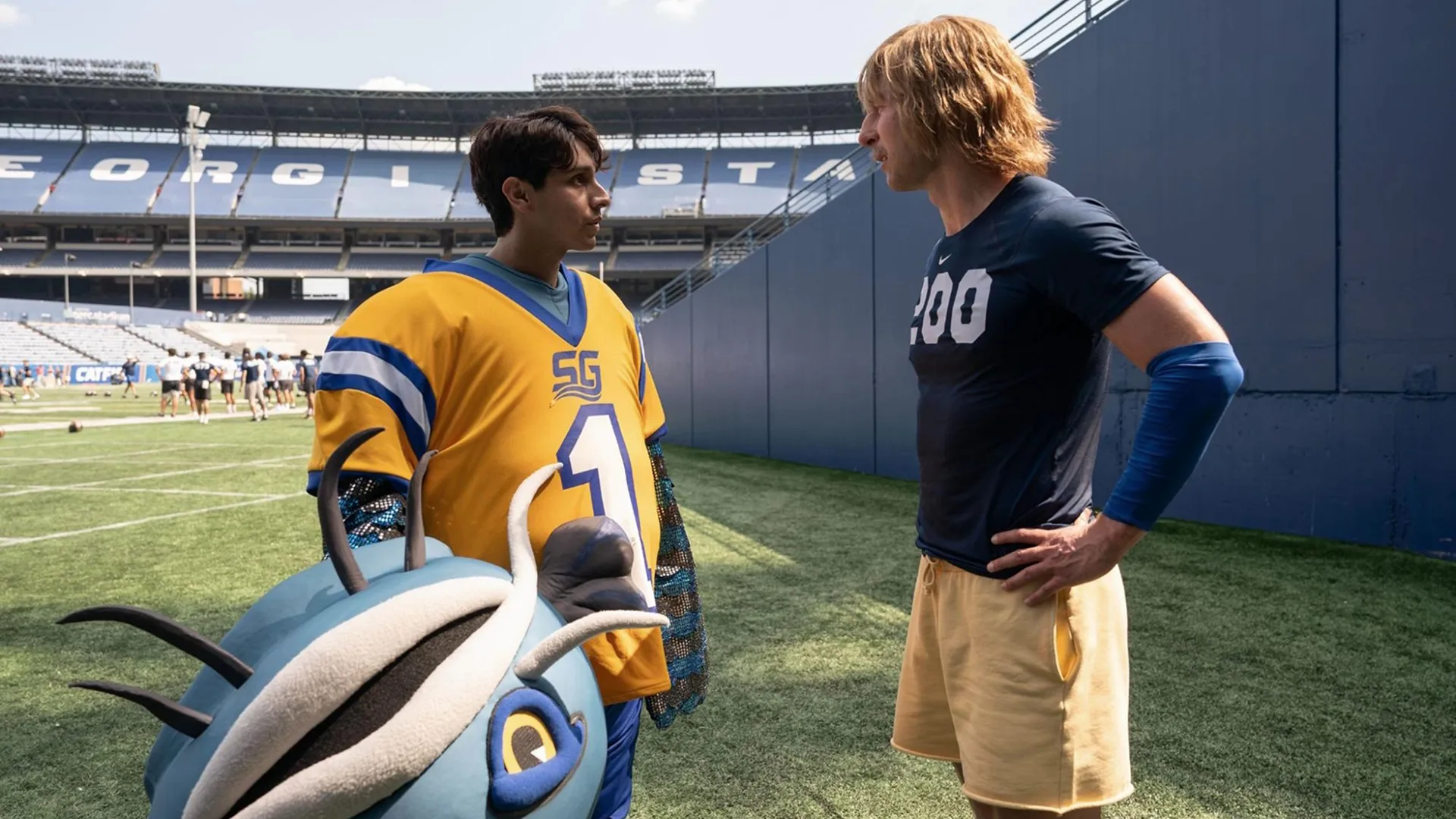 Chad Powers (Glen Powell) talks with Danny (Frankie Rodriguez) inside the stadium in the first season of Chad Powers.