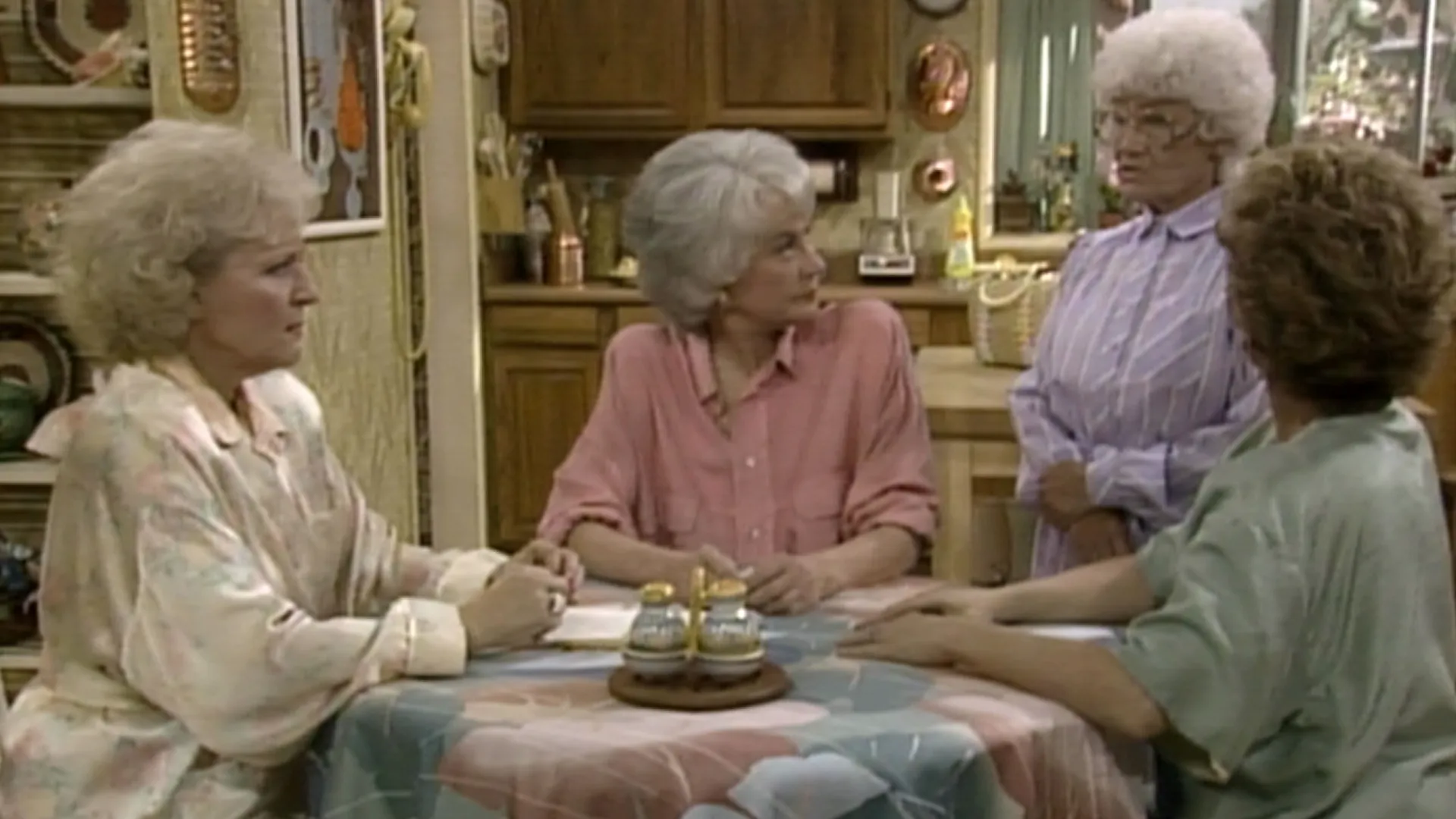 The Golden Girls around a table.