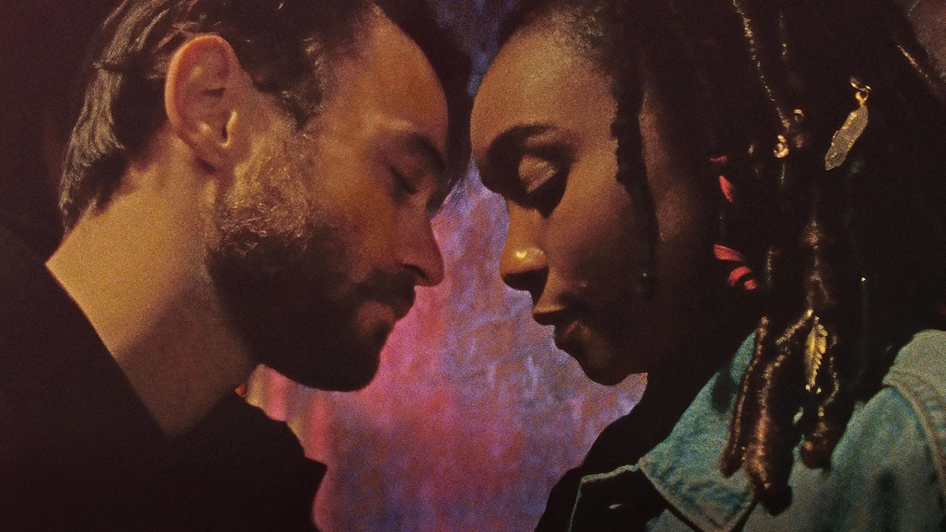 A closeup of Casey (Thomas Doherty) and Theresa (KiKi Layne) with their foreheads pressed together in Dandelion