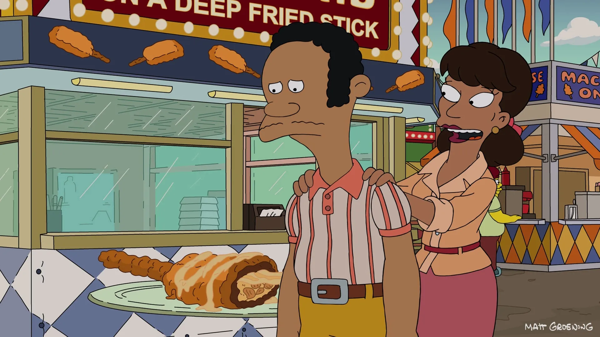 Lou looks sad and nauseous while a woman puts her hands on his shoulders in front of a carnival food stand selling items on a deep-fried stick.