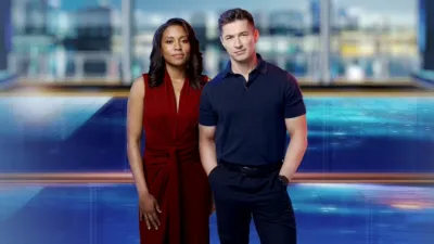 Rachel Scott and James Longman stand in front of a newsroom background.