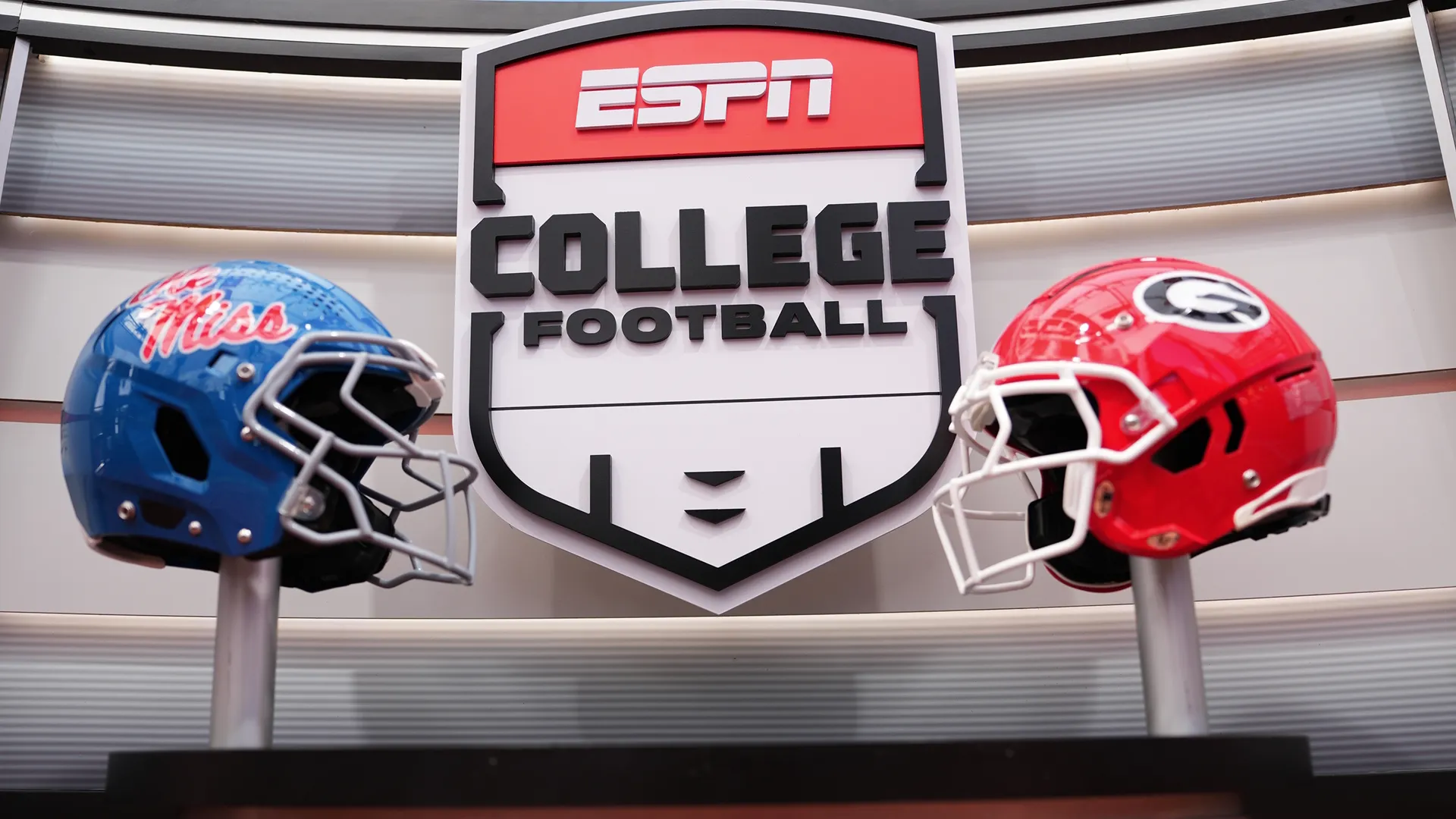 Two football helmets (L: Ole Miss Rebels, R: Georgia Bulldogs) besides the ESPN College Football logo.