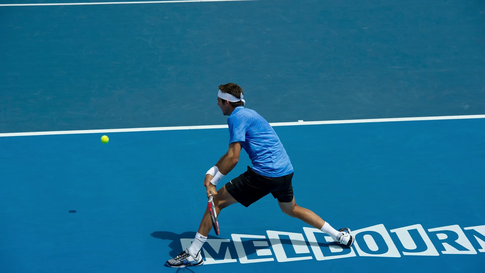 A tennis player prepares to return the ball at the Australian Open in Melbourne.