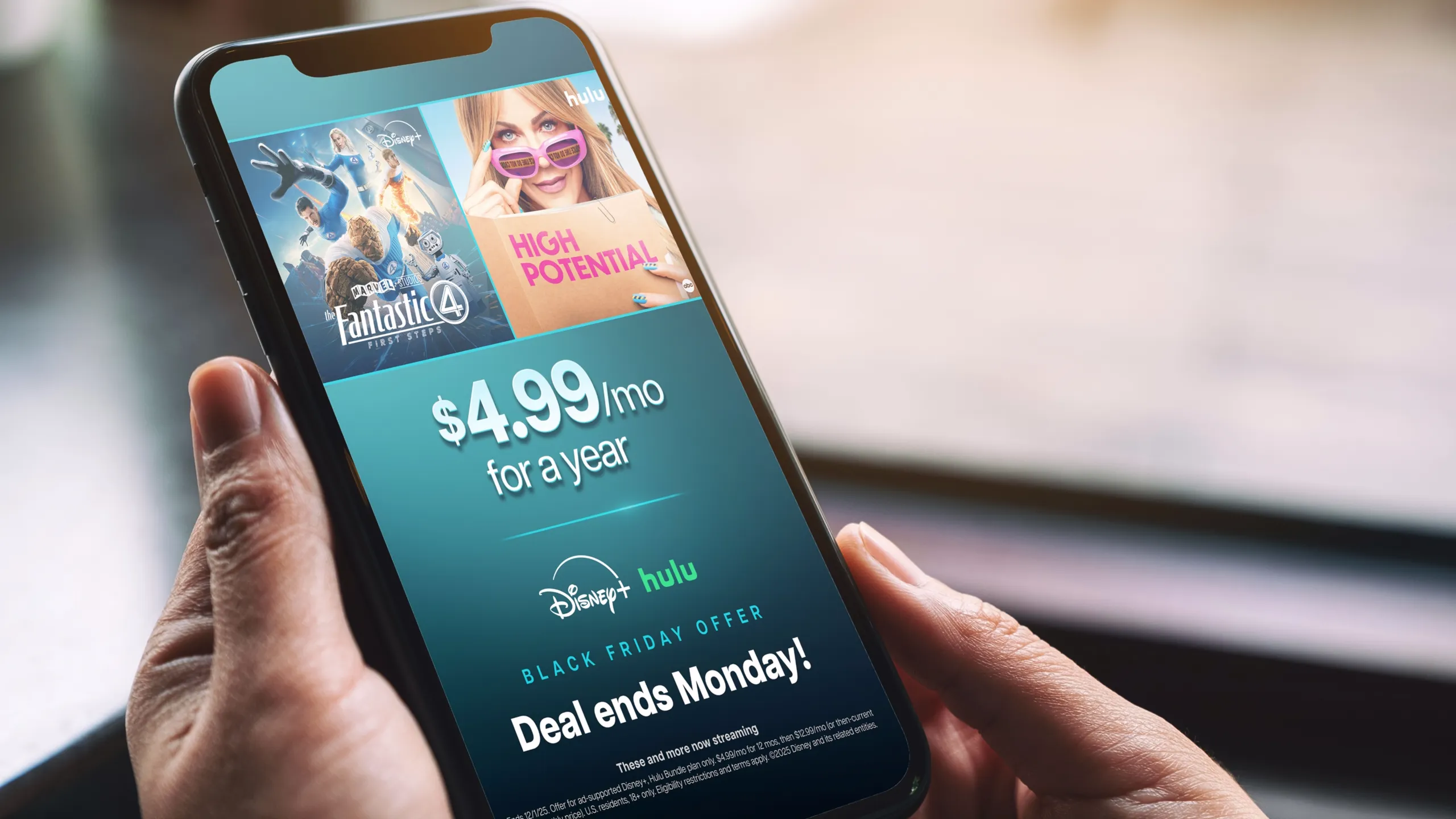 Hands holding a phone which reads "$4.99/mo for a year. Black Friday offer. Deal ends Monday!"