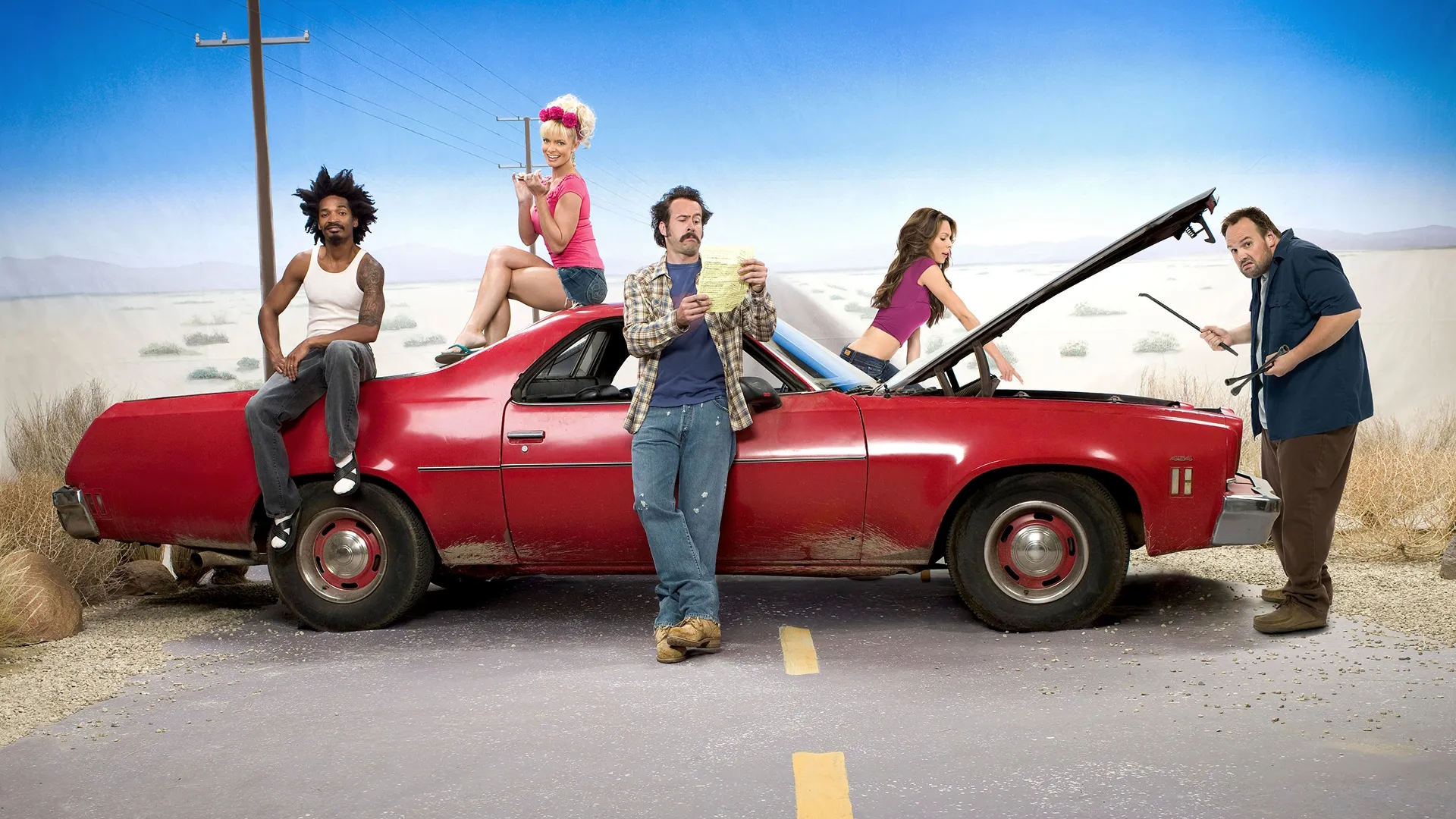 The cast of My Name is Earl are standing around a red Chevrolet El Camino