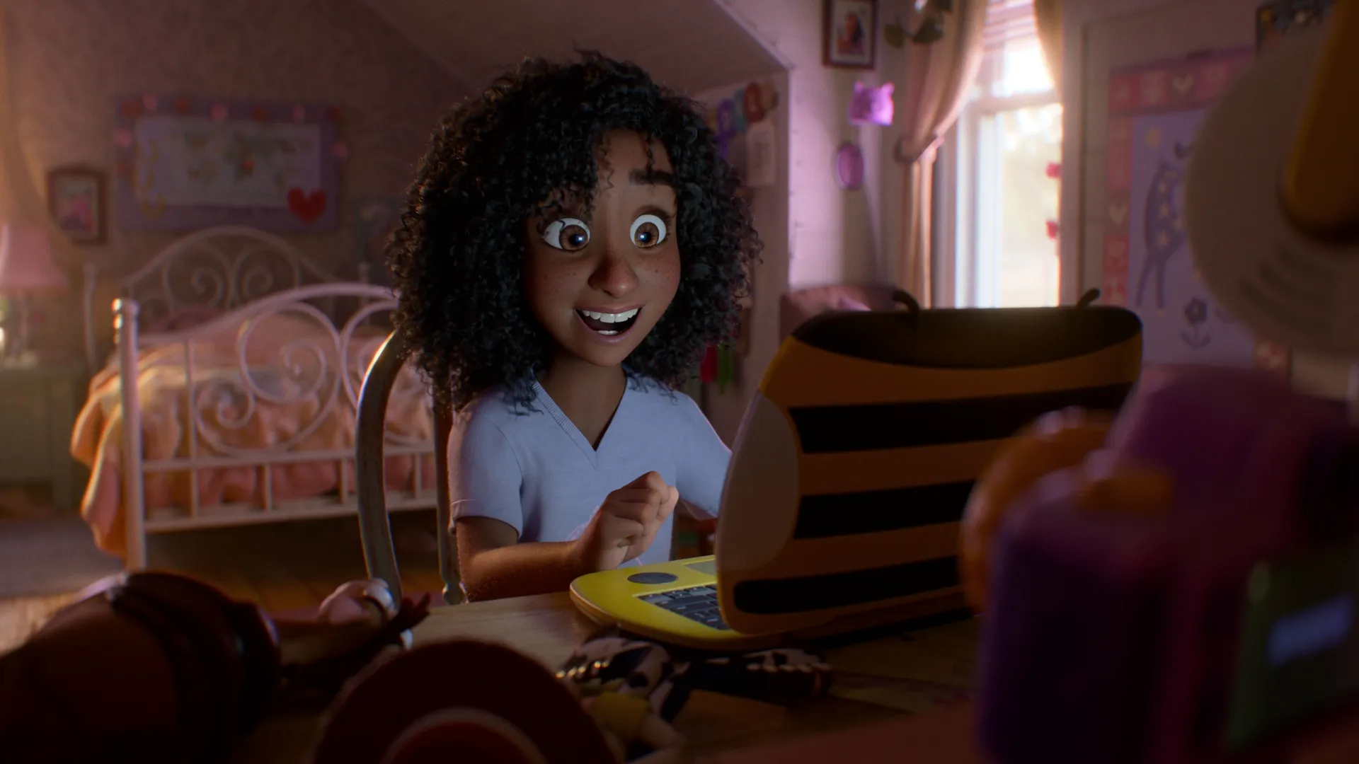 Blaze, a 9-year-old girl with curly black hair, looking excitedly at a yellow-and-black striped laptop in her bedroom from a scene in Pixar's Toy Story 5, with toy characters visible in the foreground.