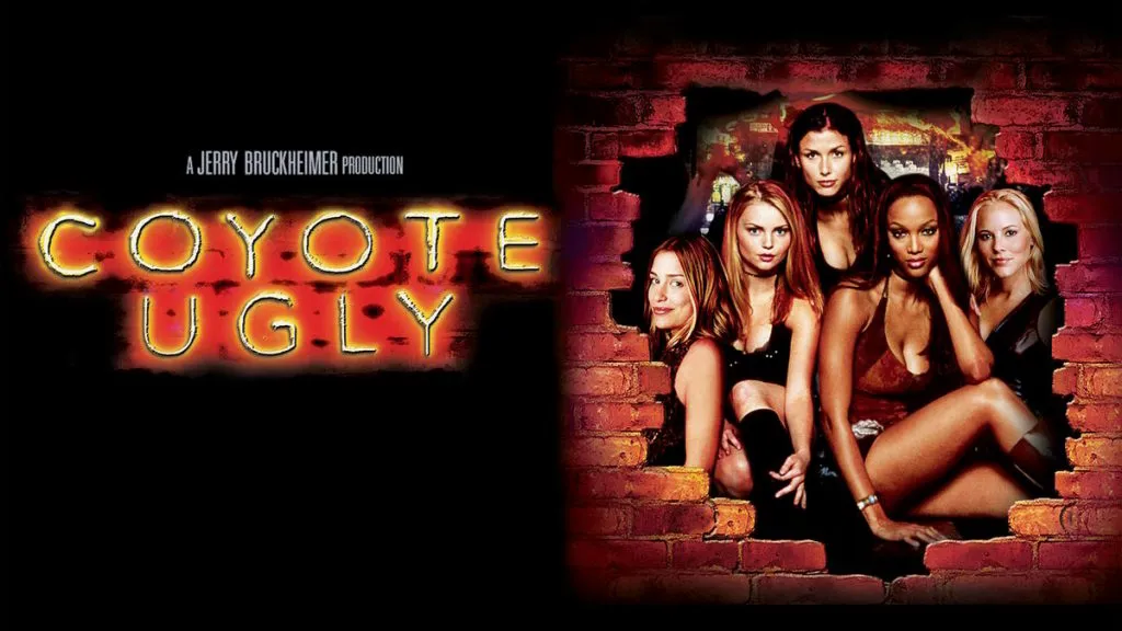 Title art for Coyote Ugly featuring the bar’s female staff posing against a brick wall with neon lights.