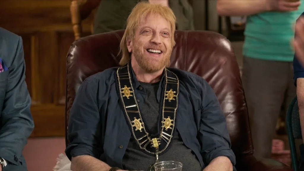 A still image of Chris Elliott as Roland Schitt in an episode of Schitt’s Creek.