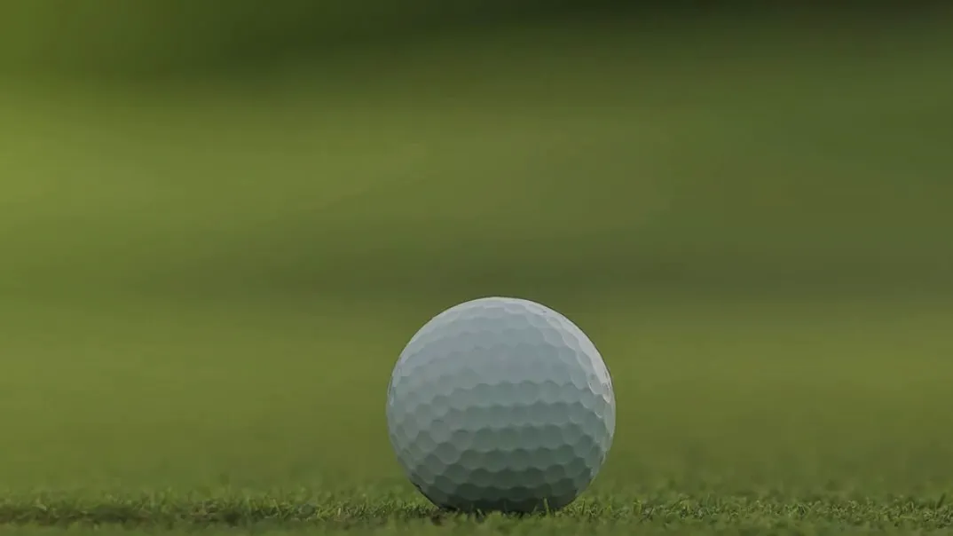 An image of a golf ball on a putting green.