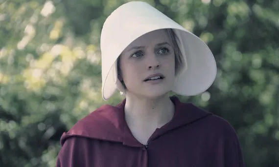 Woman wearing a red cloak and bonnet in The Handmaid’s Tale