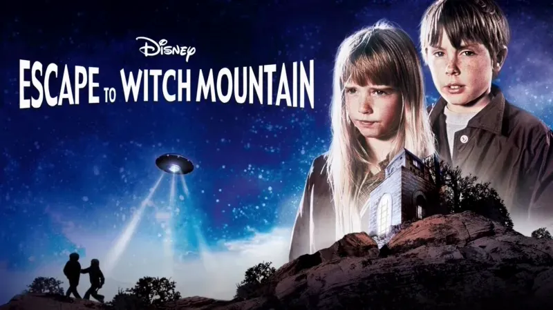 Title art for Disney’s Escape to Witch Mountain showing two children with an ominous UFO hovering above a rocky landscape.